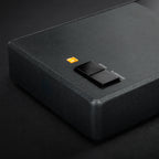 Close-up of MoFi Electronics StudioPhono phono preamp showing input and control knobs on a sleek black device.