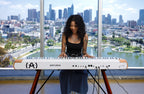 Arturia AstroLab 88 performance keyboard with black keys, full-sized piano-style keys, and control knobs for music production.