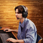 Streamer wearing the Audio-Technica ATH-M20xSTS at a laptop