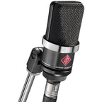 Neumann TLM 102 condenser microphone studio set with microphone, shock mount, and accessories for professional recording.
