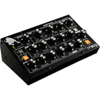Moog Minitaur synthesizer with compact design, knobs, and patch points, showcasing its black metal casing and control interface.