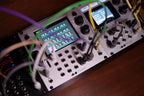 1010music Bitbox MK2 semi-modular synthesizer with colorful knobs and patch points, used in a music production setup.