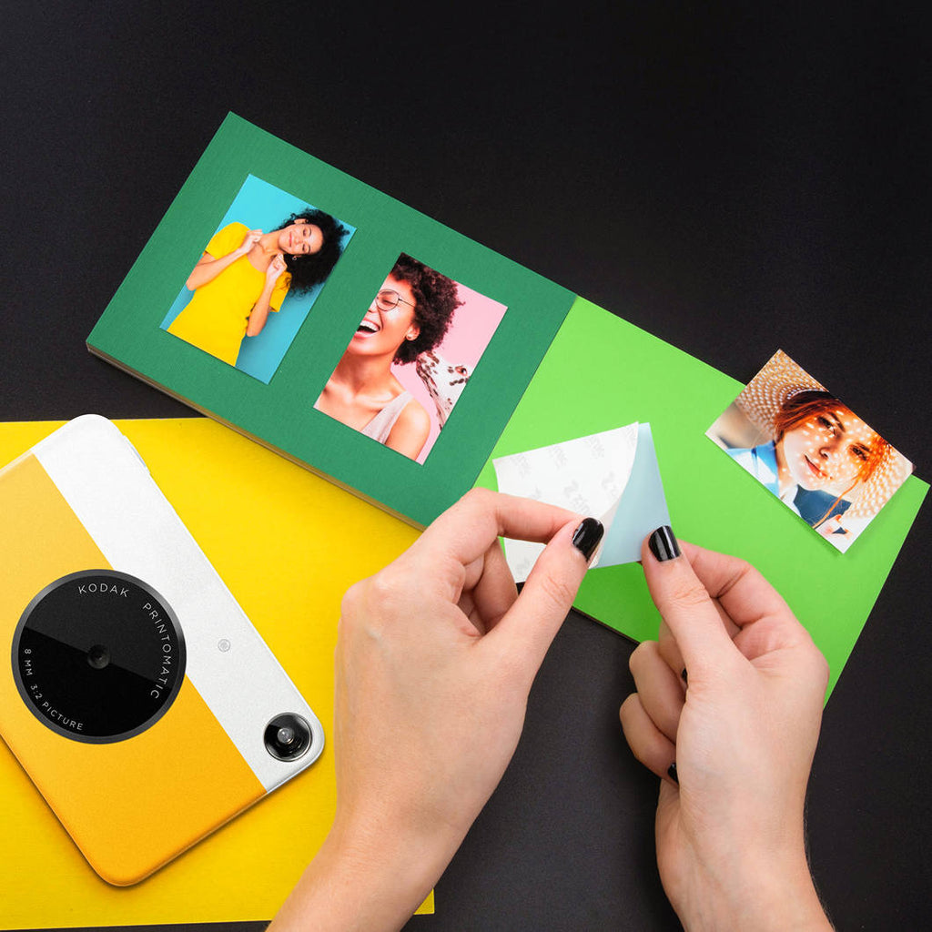 Kodak Printomatic instant compact camera with black body, ready to capture and print photos instantly.