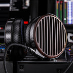 FiiO FT7 wired headphones with black ear cups and silver accents, featuring over-ear design and braided cable for high-quality sound.