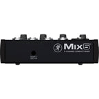 Mackie Mix5 analog mixer with multiple input channels, knobs, and audio controls, shown with connected cables and controls.
