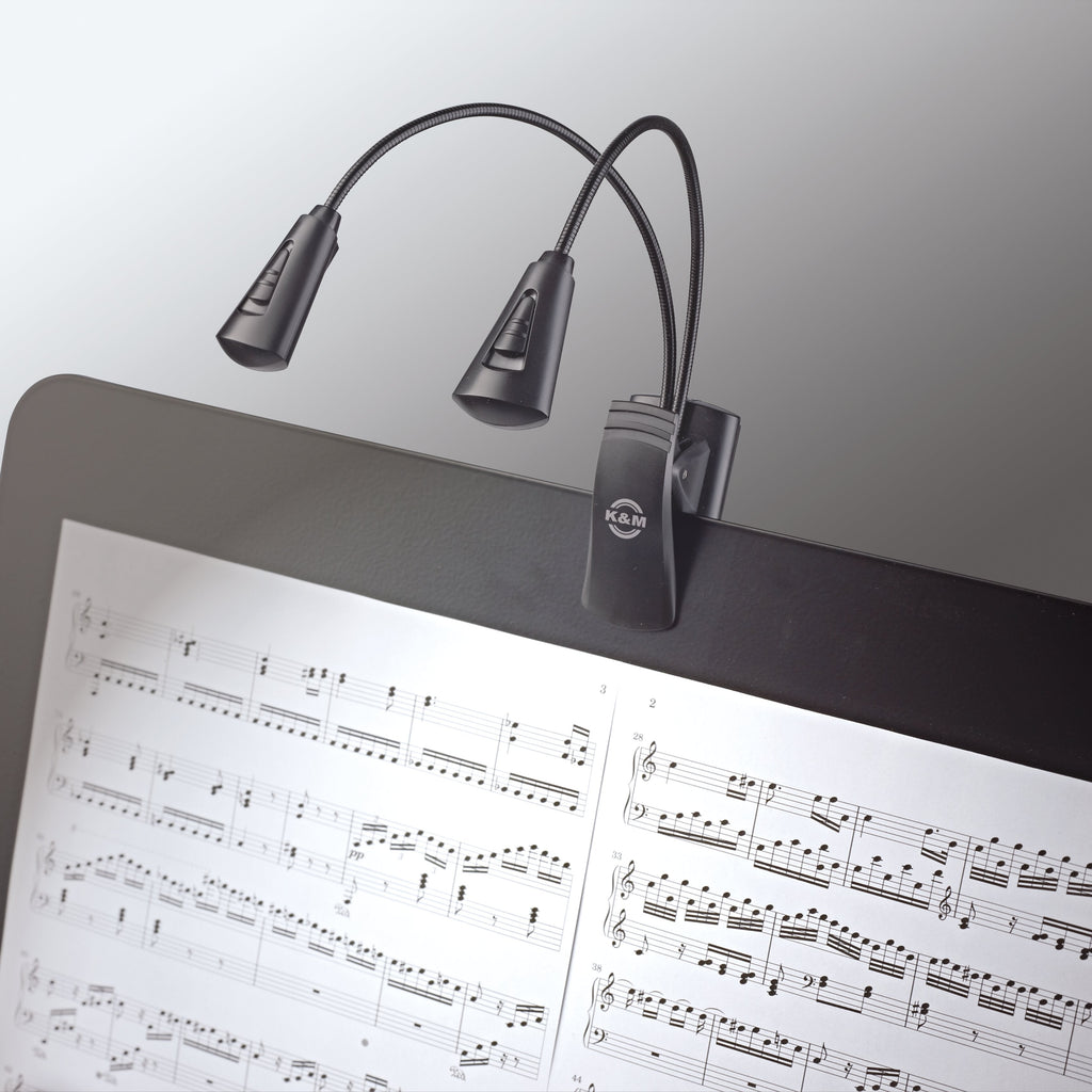 K&M 12244 music stand light attached to a music stand, adjustable LED lamp for sheet music illumination.