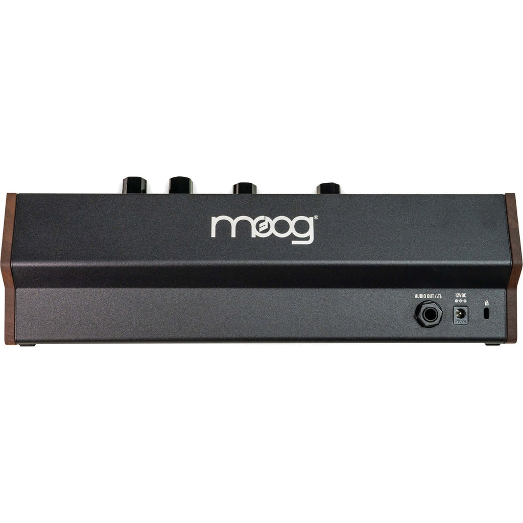 Moog Subharmonicon synthesizer with patch cables and control knobs on a wooden table, showcasing its unique modular design.