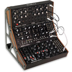 Moog Subharmonicon synthesizer with multiple knobs and patch points, showcasing its vintage-style control panel and black finish.