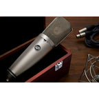 Warm Audio WA-67 condenser microphone with vintage design, featuring a large diaphragm and gold finish for studio recording.
