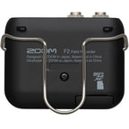 Zoom F2 digital recorder with compact design, featuring multiple input options and a built-in microphone for professional audio recording.