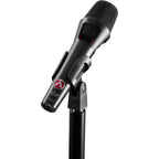 Austrian Audio OD505 dynamic microphone with black mesh grille and silver body, mounted on a stand for vocal or instrument recording.