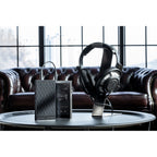Astell&Kern AK PA10 portable headphone amplifier with sleek black design and visible input ports.