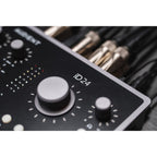 Audient iD24 audio interface with multiple input/output ports and control knobs, set on a desk with a computer and studio equipment