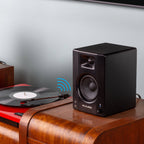 M-Audio BX3 BT desktop speakers with black finish, featuring control knobs and Bluetooth connectivity on a white surface