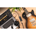 IK Multimedia iRig USB audio interface with input and output ports, compact design, and connection cables visible.