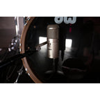 Warm Audio WA-47F condenser microphone with vintage-style grille and professional audio interface showing the microphone mounted on a stand.