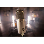 Warm Audio WA-47F condenser microphone with vintage-style metal body and gold finish, designed for studio recording.
