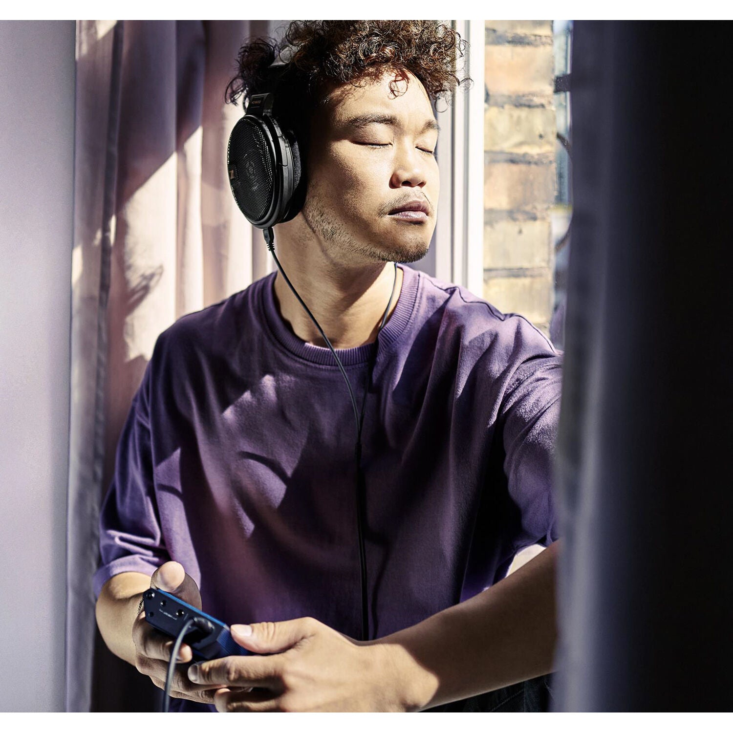 Open-back Sennheiser HD 660S2 Head-Fi headphones with large ear cups and metal accents, designed for high-fidelity audio.