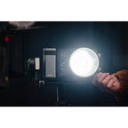 Zhiyun Molus X100 bi-color LED light with adjustable brightness and color temperature, mounted on a stand for professional video lighting.