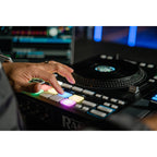 Rane Four DJ controller with dual jog wheels, mixer controls, and colorful pads for professional DJ mixing and performance.