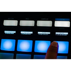 Rane Four DJ controller with dual jog wheels, mixer knobs, and colorful pads for professional DJ performance.