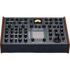 Erica Synths SYNTRX II desktop synthesizer with knobs, buttons, and screen, showcasing its compact electronic music production interface.