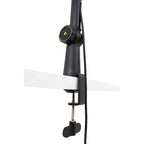 Shure SH-BROADCAST1 broadcast microphone arm mounted on a desk, adjustable metal arm for professional audio setup.