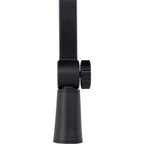 Shure SH-BROADCAST1 broadcast microphone arm mounted on a desk with a professional audio setup and adjustable arm.