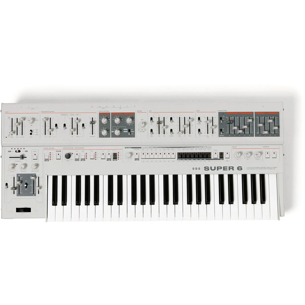 UDU Audio Super 6 synthesizer keyboard with black and silver design, featuring multiple knobs and controls on a sleek surface.