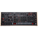 Sequential Trigon-6 desktop synthesizer with a sleek black panel, multiple control knobs, and a compact design for music production.