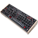 Sequential Trigon-6 desktop synthesizer with a sleek design, featuring various knobs and a digital display for sound modulation.