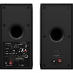 Black Klipsch R-40PM wireless speakers with sleek design and speaker grille, showcasing modern audio equipment for home sound.