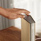 Bang & Olufsen Beosound Emerge wireless speaker in elegant gold tone, showcasing its sleek design and compact form.