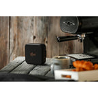 Klipsch Austin portable speaker with sleek black design and control buttons on top, ideal for portable audio enjoyment.
