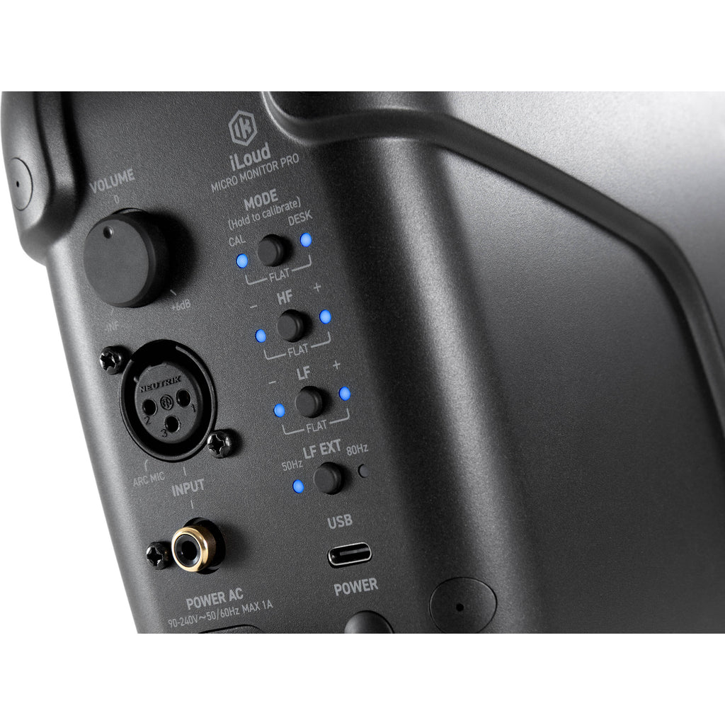 IK Multimedia iLoud Micro Monitor Pro active nearfield monitor speakers shown on a studio desk with audio equipment.