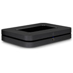 Bluesound Node 2025 black music streamer connected to audio equipment, showcasing sleek design and modern streaming features.