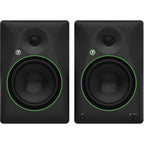 Mackie CR8BT desktop speakers with black finish, featuring control knobs and Bluetooth connectivity, on a wooden desk setup.