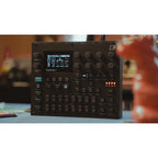 Elektron Digitone II synthesizer with multiple control knobs and a digital display, showcasing its compact, modern design.