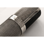 Warm Audio WA-CX24 condenser microphone with metal body and grille, suitable for studio recording and vocal capturing.