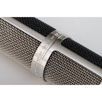 Warm Audio WA-CX24 condenser microphone with metal body and grille, suitable for studio recording and vocals.