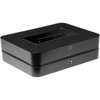 Bluesound Powernode 2025 music streamer with sleek black design and front panel controls, connected to audio equipment.