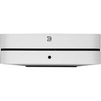 Bluesound Powernode 2025 music streamer with sleek black design and front display, connected to audio equipment.