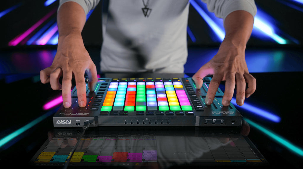 Akai Professional APC64 MIDI controller with grid of pads, knobs, and faders viewed from the top angle.