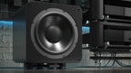 IsoAcoustics Aperta SUB XL speaker stands supporting a subwoofer, featuring sleek design and sturdy construction for optimal audio support.