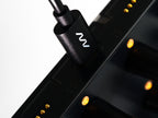 Close-up of Intech Studio EN16 Detent Series 3 MIDI controller with knobs and buttons on a sleek black surface.