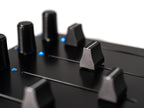 Close-up of Intech Studio EF44 Detent Series 3 MIDI controller with knobs and buttons, showing detailed control surface.