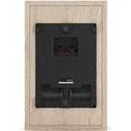 DALI Sonik On-Wall in-wall and outdoor speakers mounted on a wall, showcasing sleek design and grille details.