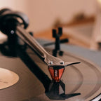 Close-up of the Ortofon 2M Red Verso turntable cartridge showing its stylus and body details.