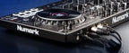 Numark NS4FX DJ controller with sliders, knobs, and pads for professional mixing and DJ performances.