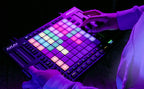 Akai Professional APC64 MIDI controller with grid of 64 colorful pads and control knobs for music production and performance.
